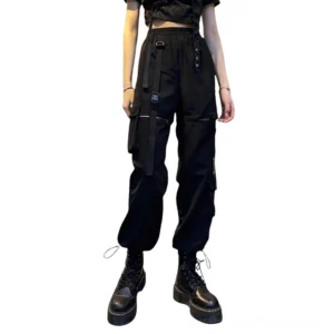 Black gothic cargo pants with hollow cutout and metal buckle straps, high-waist silhouette on fashion model, front full-body view against white studio background