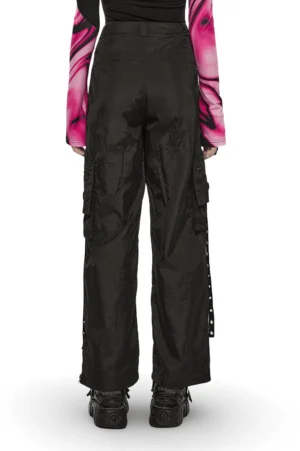 Black cargo pants with metal chains and zippers worn by model, rear full body perspective showcasing side strap details