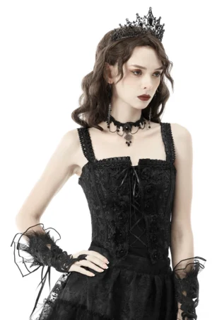 Black lace-up gothic corset front view with beaded rose embellishments, sweetheart neckline, and ruffled straps worn by model with gothic accessories