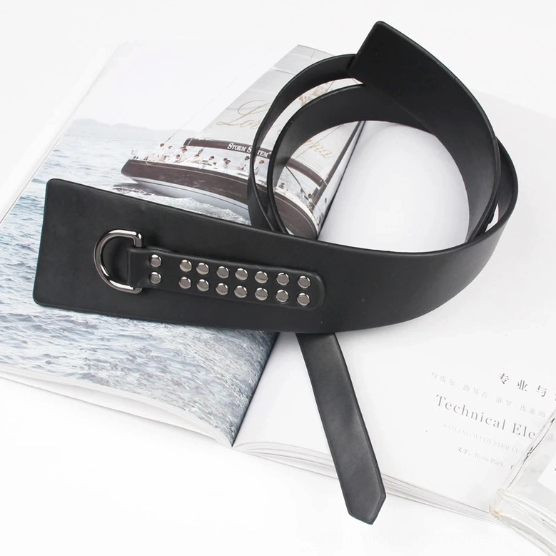 Oblique angle flat lay of black leather gothic corset belt featuring silver rivet decoration and silver pin buckle hardware