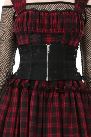 Black gothic lace-up corset belt with metal zipper on model wearing fishnet sleeves and plaid dress