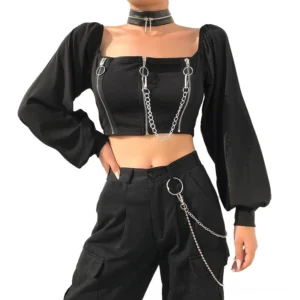 Black gothic off-shoulder crop top with silver zippers and chain details, front view on model