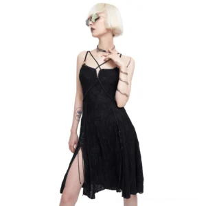 Black gothic cross strap slip dress with asymmetric slit hem front view on model