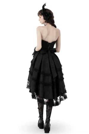 Black gothic lace dress back view showing dramatic back bow and tiered high-low hemline with ruffled layers