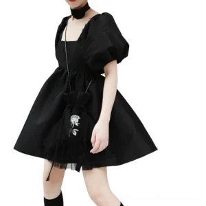 Gothic black mini dress front view showing square neckline and puff sleeves on model with gothic accessories