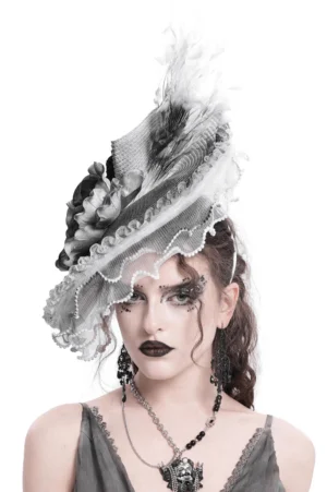 Black gothic fascinator hat with feathers and white floral accents, front view on model with gothic styling
