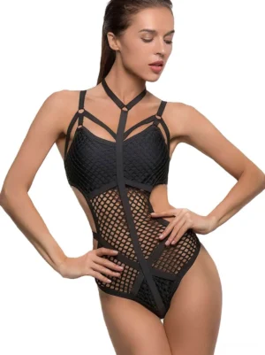 Black fishnet one-piece monokini with halter neck and crisscross waist straps - front three-quarter view on model