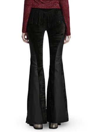 Black gothic flare pants with v-shaped back tassel trim and crushed velvet panels, back view on model
