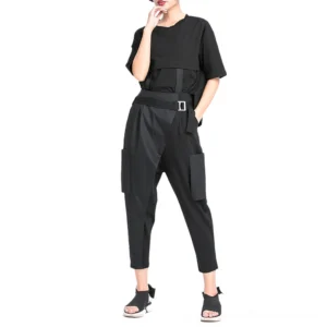 Black gothic harem cargo trousers with asymmetrical panel and high waist belt, front three-quarter view on female model