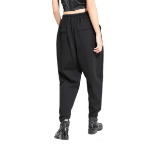 Black gothic harem trousers rear view showing elasticated waistband and back patch pockets on female model