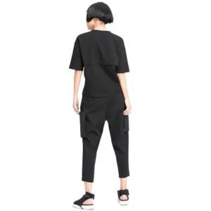 Black gothic cargo harem trousers rear view showing cropped tapered legs and back pockets on female model