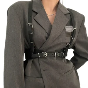 Black gothic leather harness belt with adjustable silver buckles worn by model in gray blazer