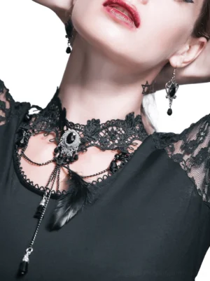 Black gothic lace crystal choker necklace with feather charm and silver filigree details, close-up view on model