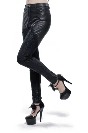 Black gothic lace appliqué faux leather leggings three-quarter view on model showing floral lace panels on thighs and calves