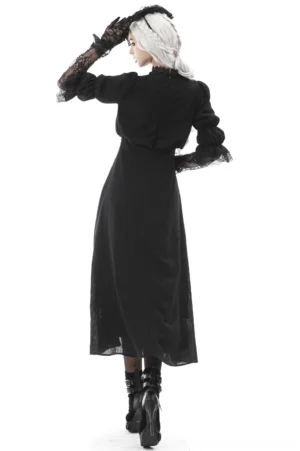Black gothic maxi dress back view displaying hidden zipper closure, ruched yoke detail, and floor-length elegant skirt with platform boots