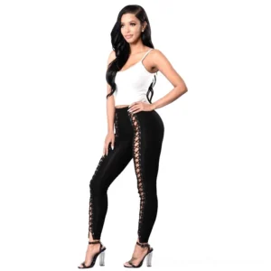 Black lace-up gothic leggings with hollow cutout details, high waisted pencil fit, front three-quarter view on model