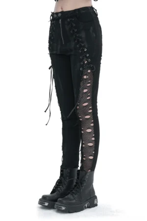Black gothic lace-up punk trousers with fishnet side panels worn on model, side view showing symmetrical lace-up details and metal eyelets