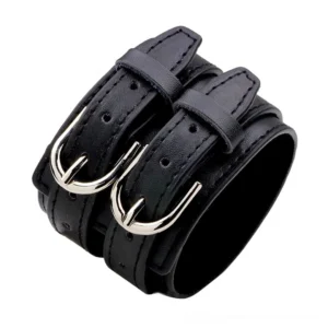 Black genuine leather wide double-strap gothic bracelet with silver toggle clasp and metal buckles, displayed on white background showing adjustable length and industrial design