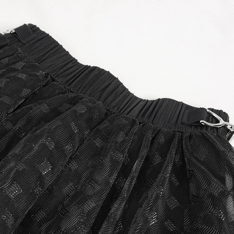 Model wearing black mesh gothic skirt styled with accessories and platform boots, full-length side view showing hem movement