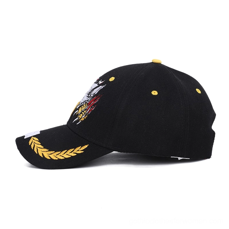 Black gothic eagle cap showing side profile with detailed embroidery and golden ventilation eyelets