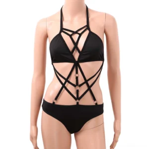 Black gothic strappy monokini on mannequin, direct front view displaying halter neck and crisscross cutout design with metal ring accents