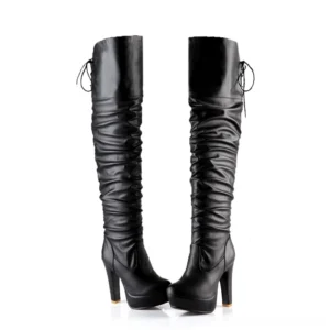 Pair of black gothic over-the-knee platform boots with ruched shaft and back lace-up detail, front view