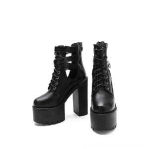 Black gothic platform lace-up ankle boots with metal buckle straps and cutout sides, front three-quarter view showing thick square heel and round toe silhouette