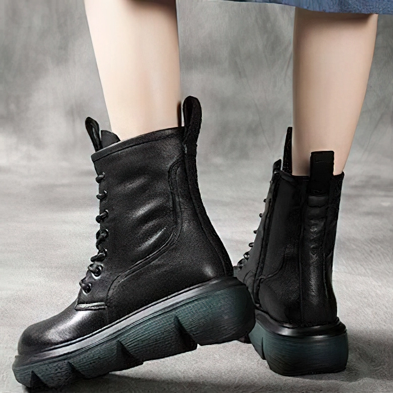 Black gothic platform combat boots showing lace-up closure system and heel pull tab design