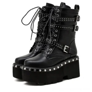 Black gothic platform ankle boots with studded buckles, lace-up design, and chunky platform sole, front three-quarter view