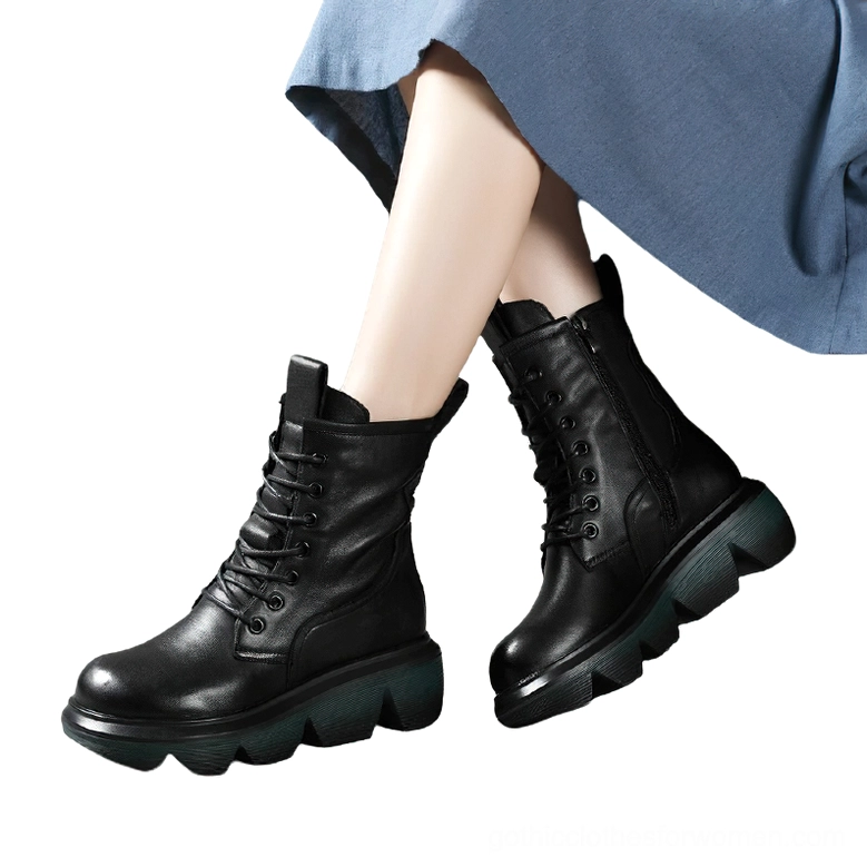 Black gothic platform combat boots worn on model's feet with blue skirt, low side angle view