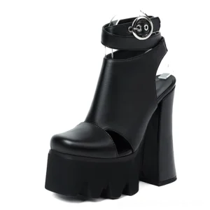 Black gothic platform ankle strap heels with scalloped sole, front view on white background