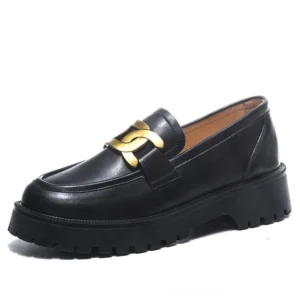 Black gothic platform loafers with chunky rubber sole and gold chain accent, three-quarter side view showcasing sleek leather upper and architectural platform design