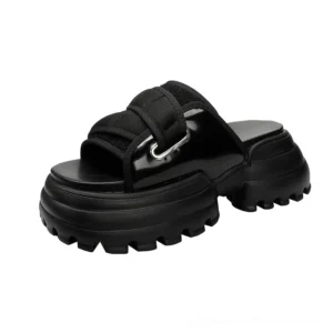 Black gothic platform slide sandals with chunky lug sole and adjustable buckle strap, three-quarter front view