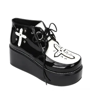 Single black gothic platform shoe with cross appliqué and rivet details, left three-quarter view displaying lace-up closure and patent leather finish