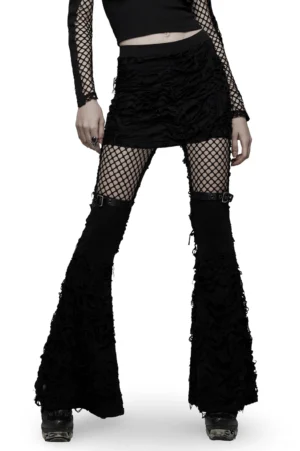 Black gothic ripped flare pants with mesh thigh panels and attached mini skirt, front 3/4 view on model