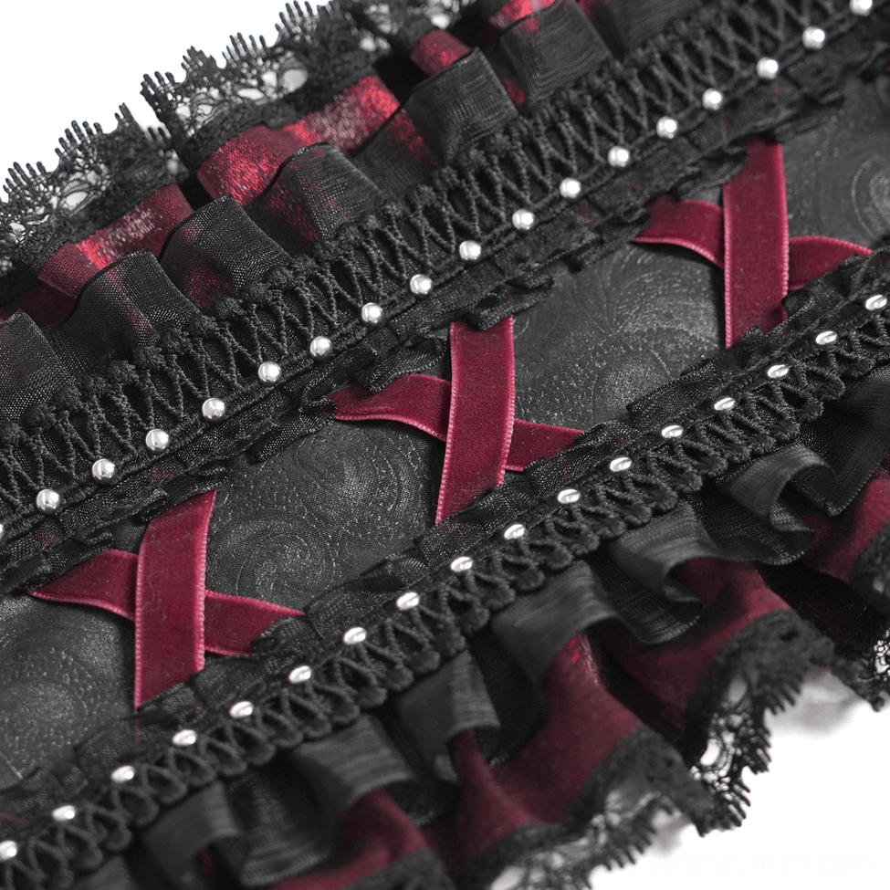 Close-up macro detail of black Victorian bonnet fabric showing intricate black lace, wine-red fabric, pearl studs, and decorative cross straps