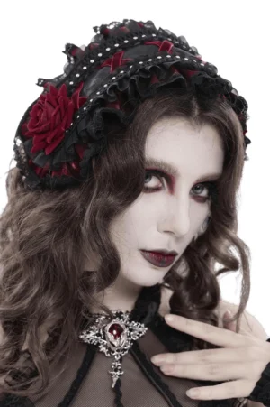 Black Victorian gothic rose bonnet with layered lace ruffles and pearl studs, worn on model with dark gothic makeup and pale skin