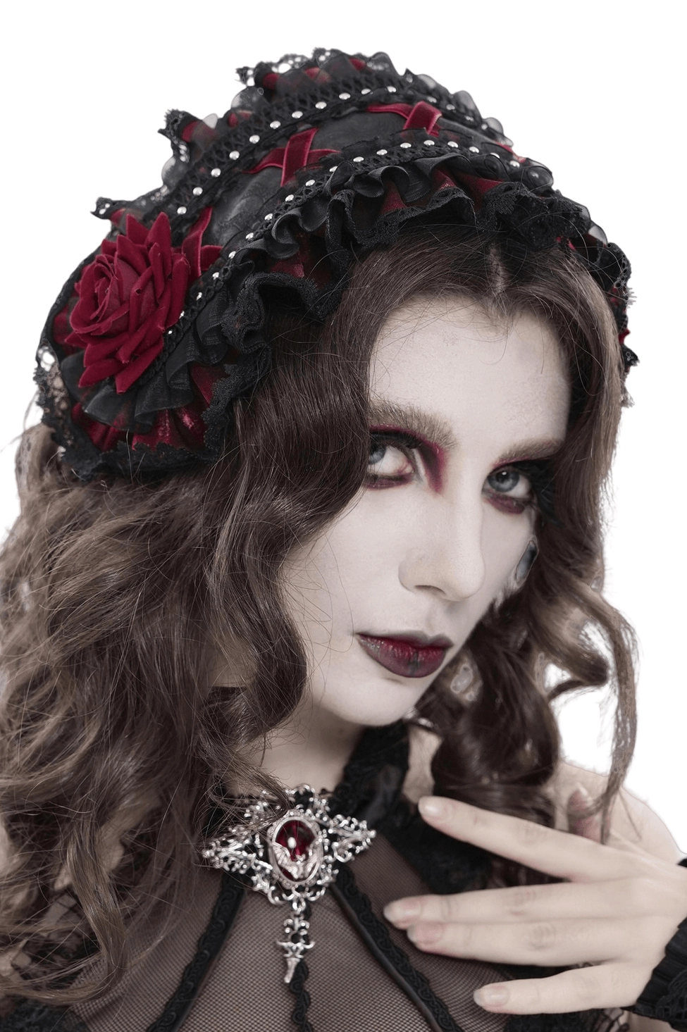 Black Victorian gothic rose bonnet with layered lace ruffles and pearl studs, worn on model with dark gothic makeup and pale skin