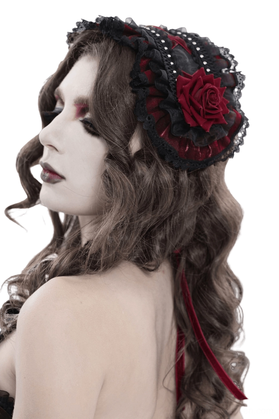 Side back view of black Victorian Lolita bonnet showing wine-red rose and black lace trim detail on curly-haired model
