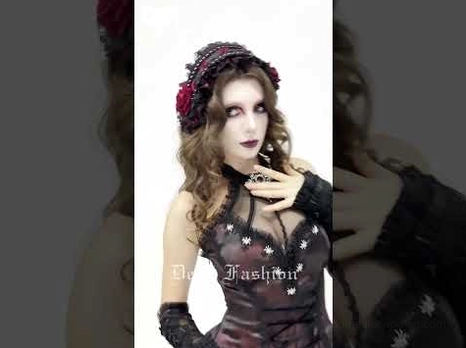 Black Victorian gothic rose bonnet styled with matching gothic formal outfit on model, three-quarter view