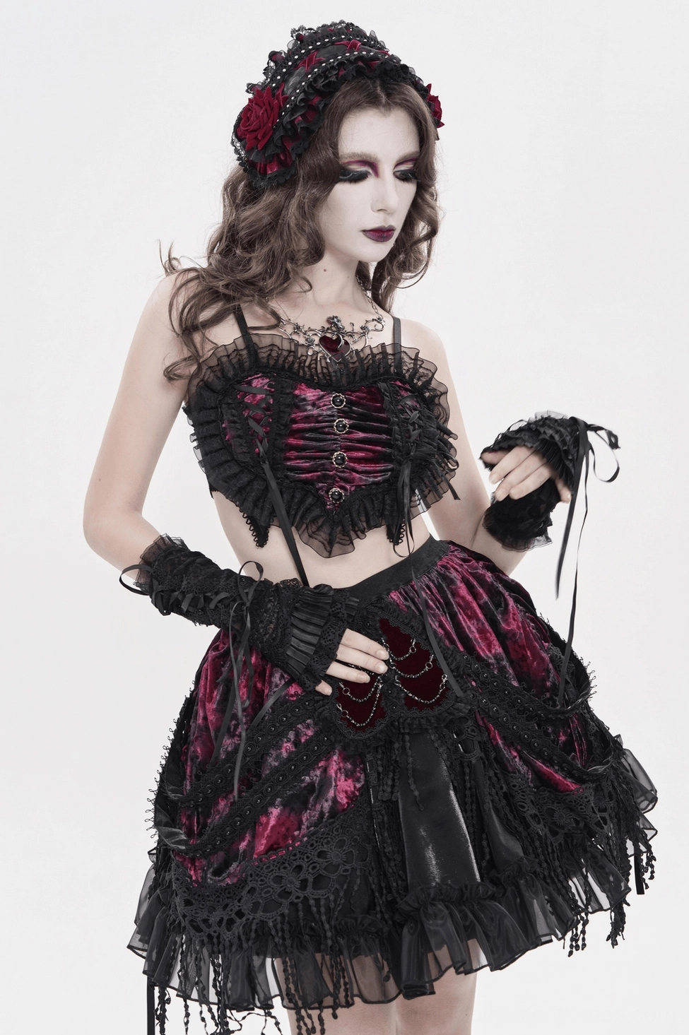 Black gothic rose bonnet detail view highlighting wine-red rose embellishment and pearl stud placement
