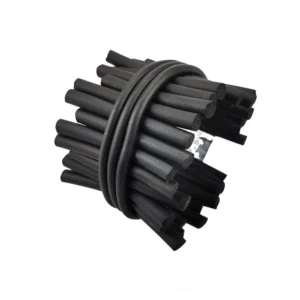 Top-down close-up of coiled black punk rock rubber bracelet displaying matte finish and geometric bundled stick structure