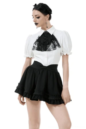 Black gothic ruffle mini skirt with satin bow worn with white lace blouse, front three-quarter view on model