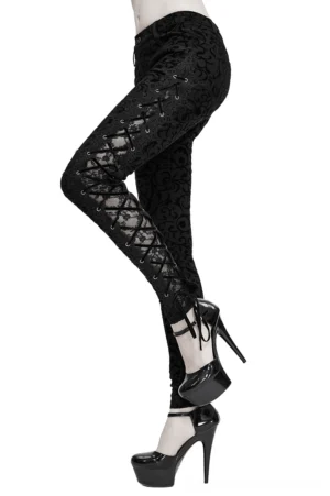 Black gothic side lace-up leggings with ornamental flocking, shown on model in side three-quarter view with platform heels