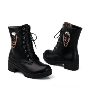 Side profile of black lace-up platform boots featuring antique gold skull decoration and aggressive lug rubber sole