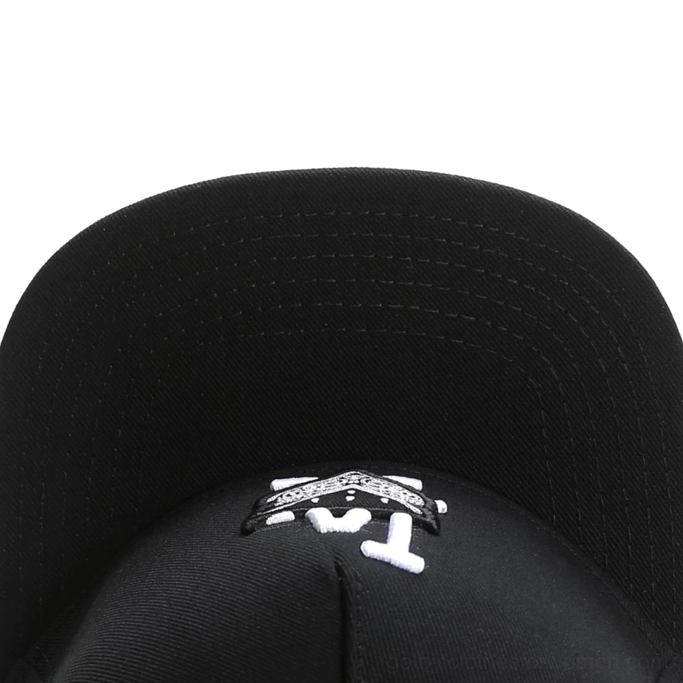 Black gothic snapback cap interior close-up showing embroidered LA badge logo and stitching detail on brim