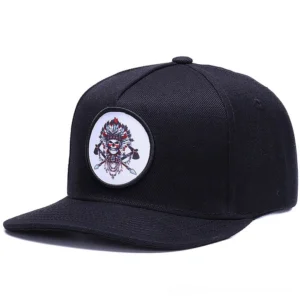 Black gothic snapback cap with embroidered round skull badge - front angle view for alternative fashion