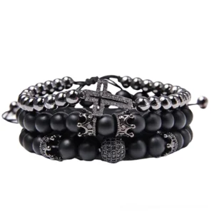 Black gothic multi-strand bracelet set with volcanic stone beads, cross pendant and ornate charms, front flat view on white background