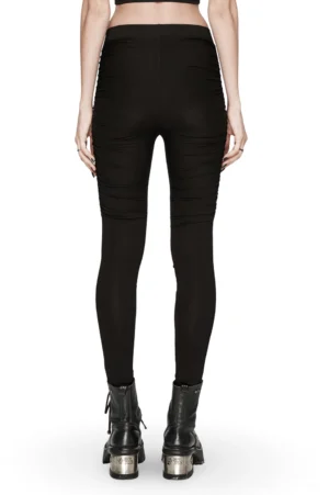 Rear full-length view of high-waisted black gothic leggings on model, showcasing slim-fit silhouette and stud-adorned pleats from back