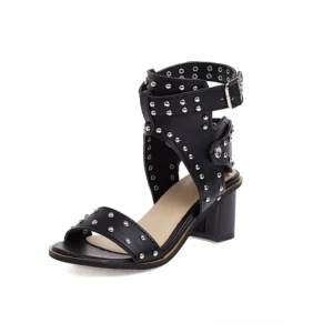 Black gothic studded block heel sandals with metal rivets and adjustable buckle strap, three-quarter side view